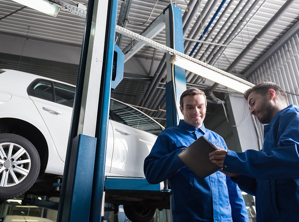 Mechanics looking over a service inspection list - Car Servicing Wellingborough